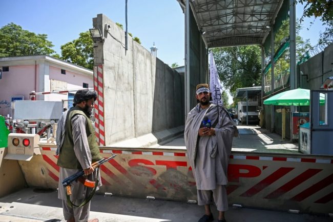 Taliban fighters stand guard at an entrance of the green zone area in Kabul on August 16, 2021 [WAKIL KOHSAR/AFP via Getty Images]